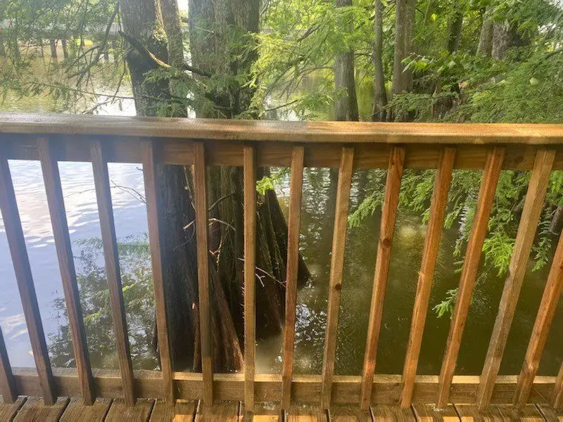 After, the same rail, wood tone back, no stripping or sanding